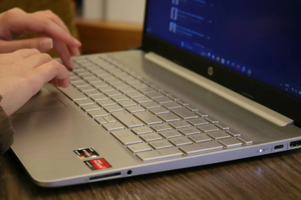 Hand Typing Computer Screen